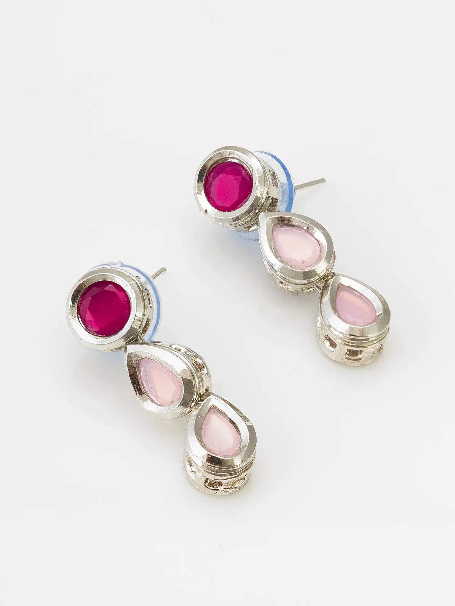 A pair of silver-toned drop earrings featuring a round magenta pink stone at the top and three teardrop-shaped pale pink stones below, displayed on a clean white background.