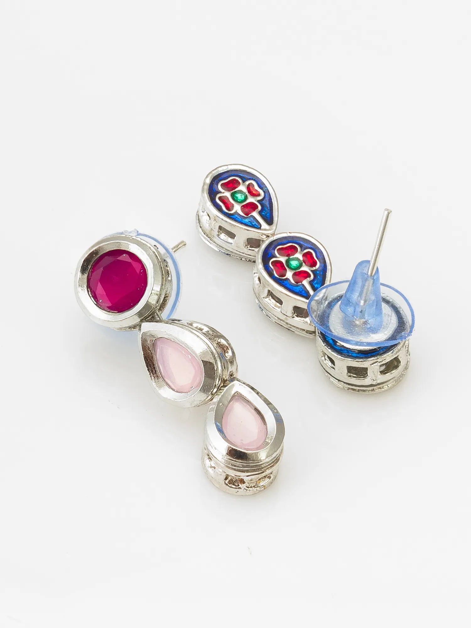 A pair of silver-toned stud earrings with colorful enamel floral details and teardrop-shaped pink and magenta inlays, shown on a plain white background.