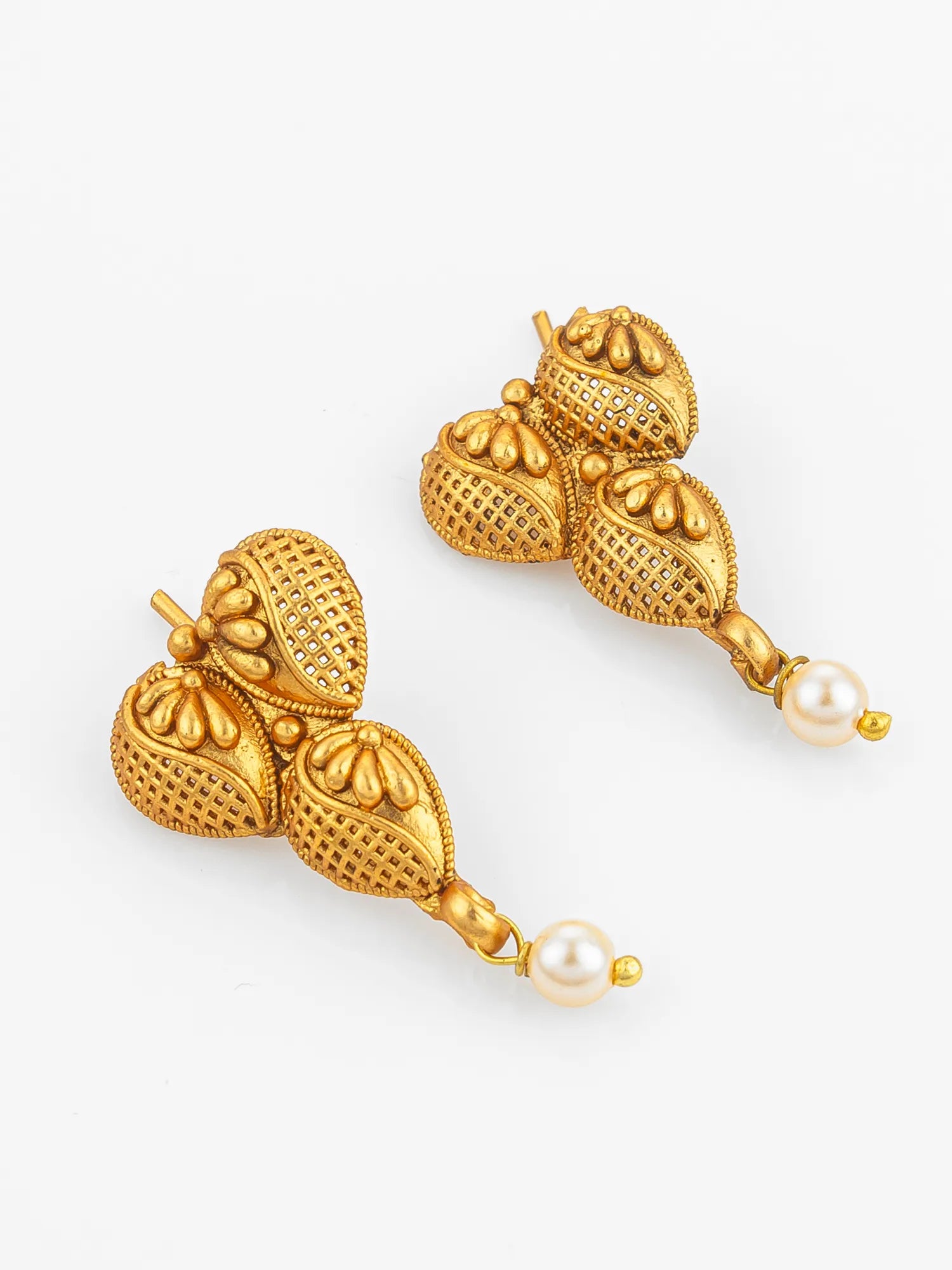 Gold earrings with pearl drops on a white background