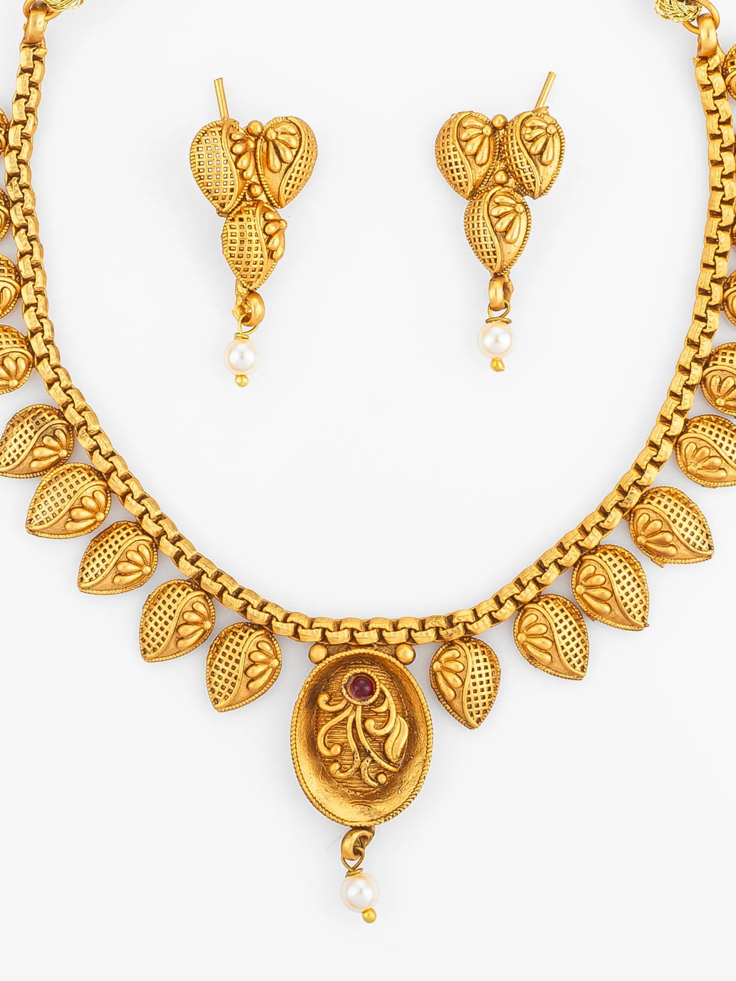 Gold necklace and earrings set on a white background