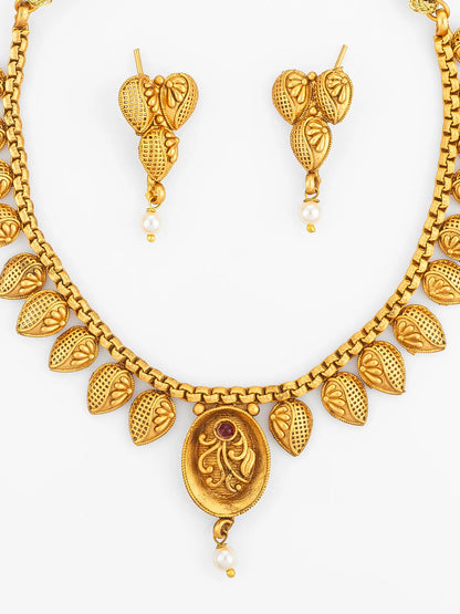 Gold necklace and earrings set on a white background