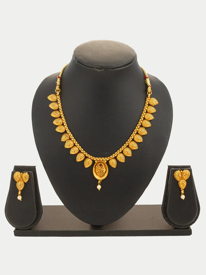 Gold necklace and earrings set on a black mannequin bust with a white background