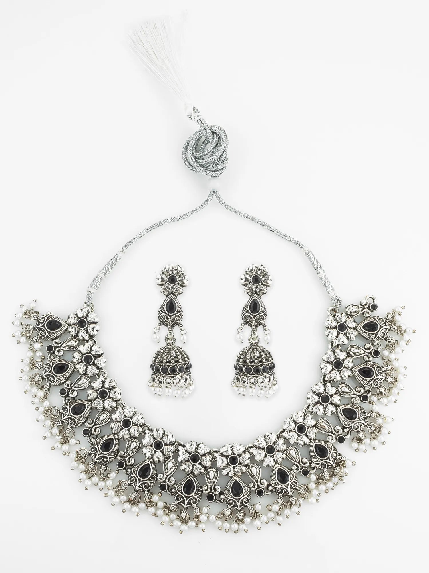 Silver necklace and earrings set on a white background