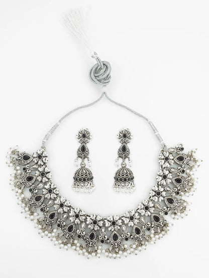Silver necklace and earrings set on a white background