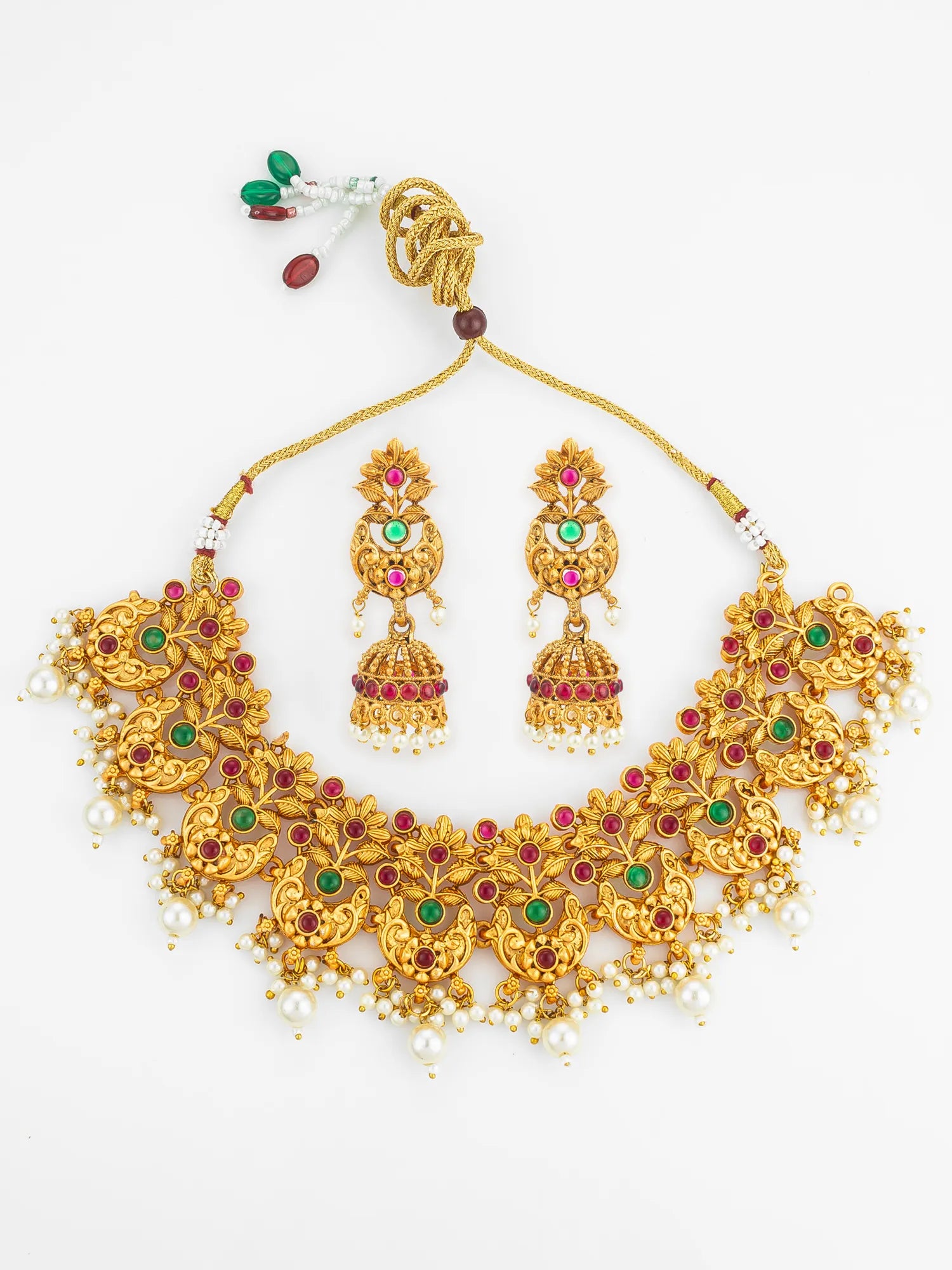 Gold necklace with matching earrings on a white background