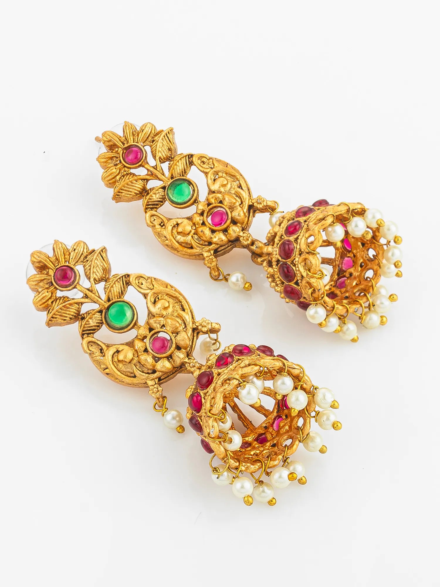 Gold earrings with gemstones and pearls on a white background