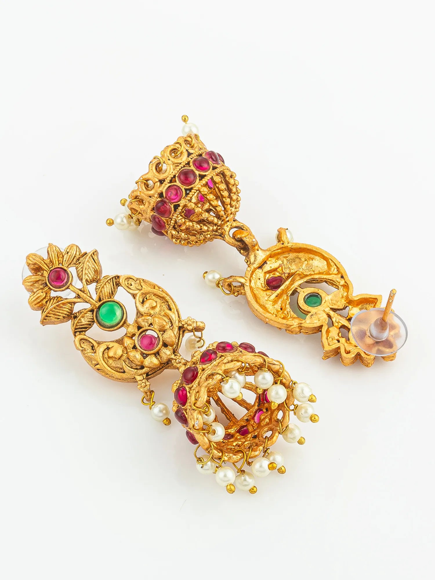 Gold earrings with gemstones and pearls on a white background