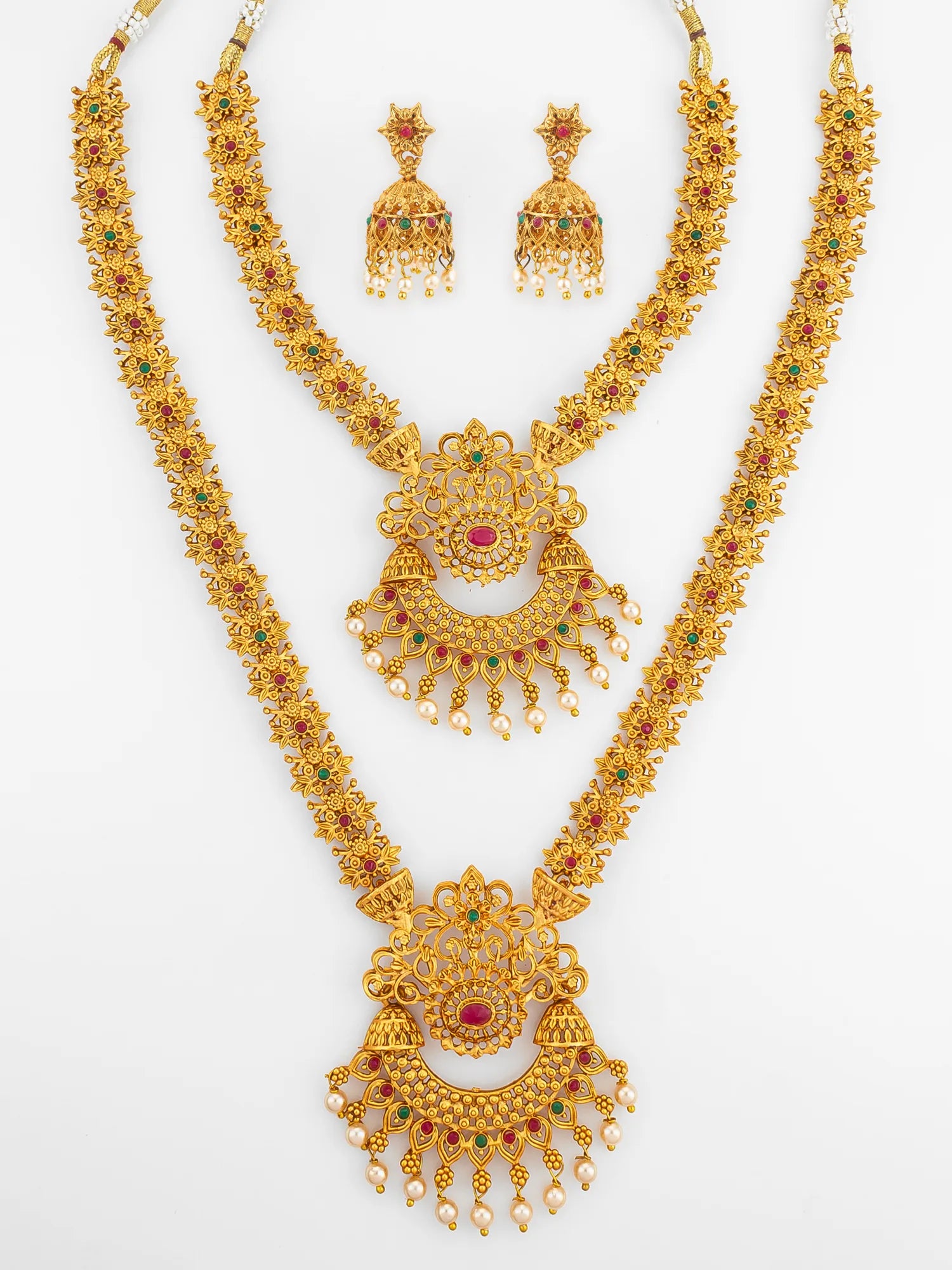 Gold necklace set with matching earrings on a white background