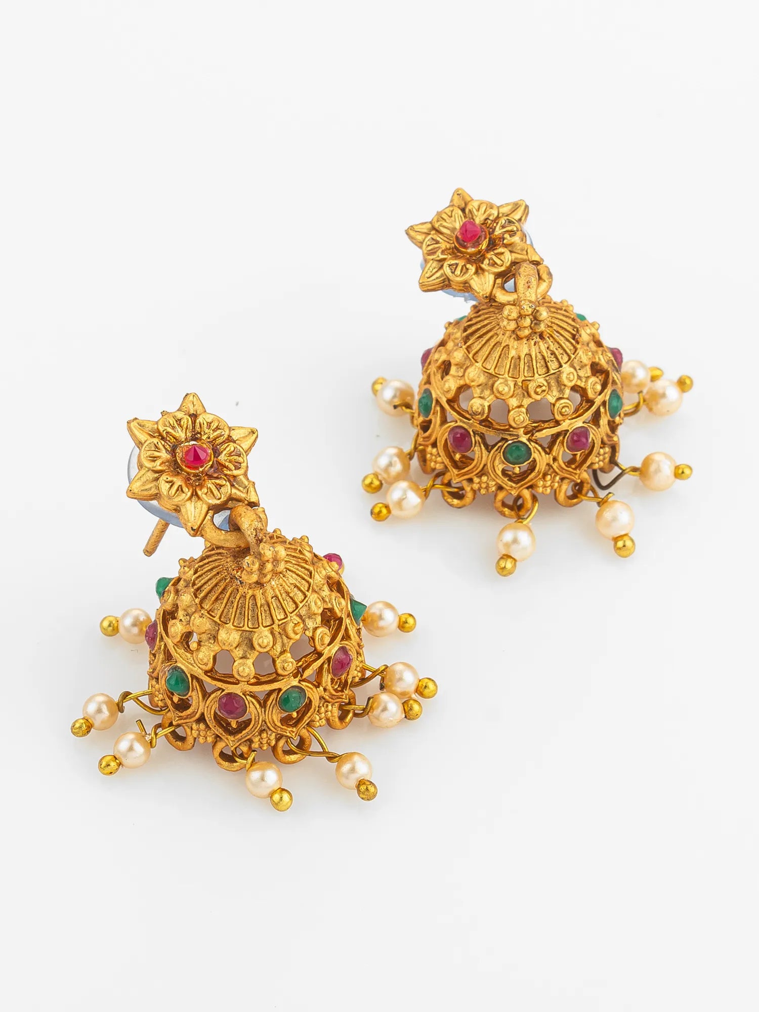 Pair of gold earrings with gemstones and pearls on a white background