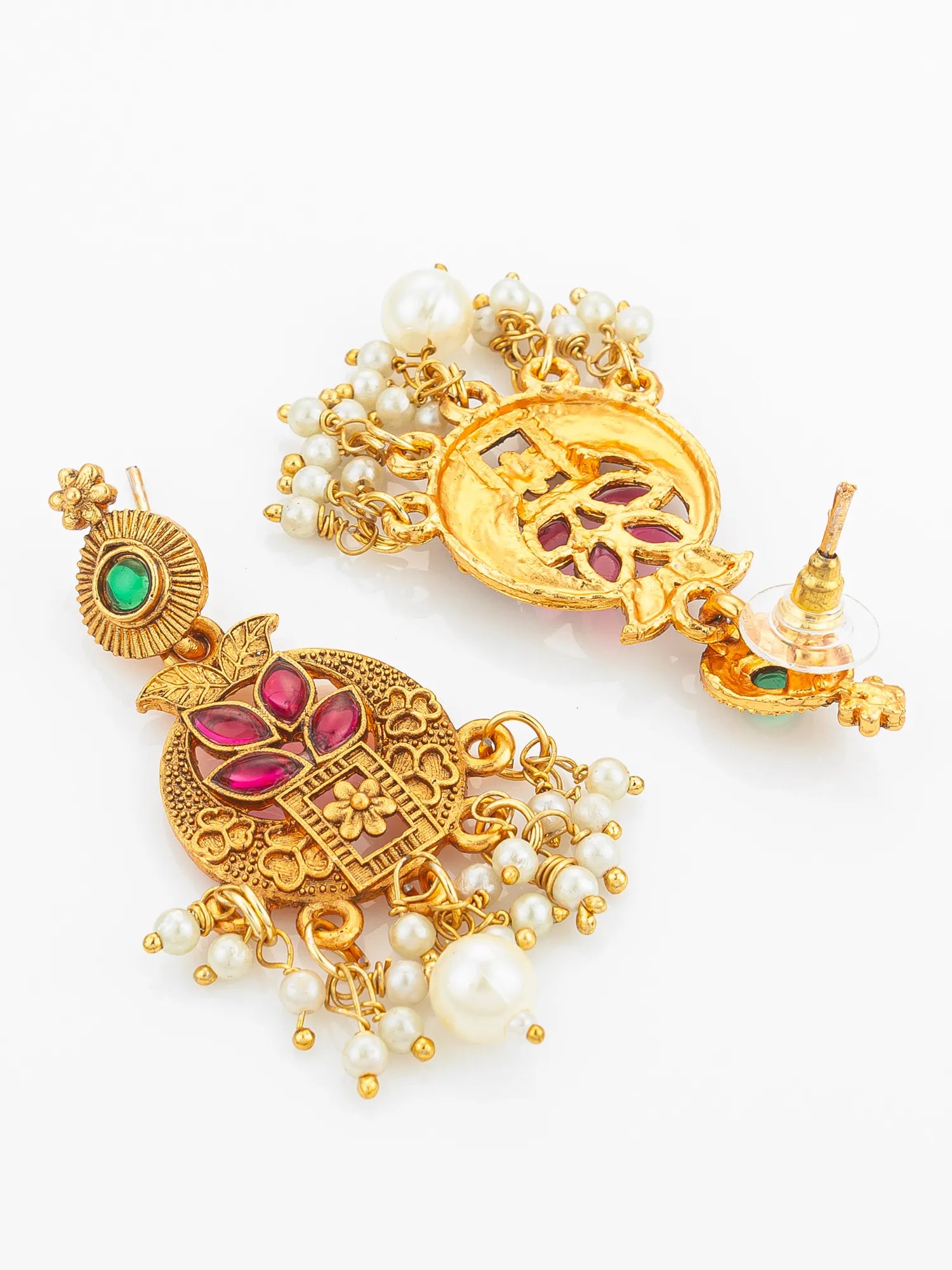 Pair of gold earrings with gemstones and pearls on a white background