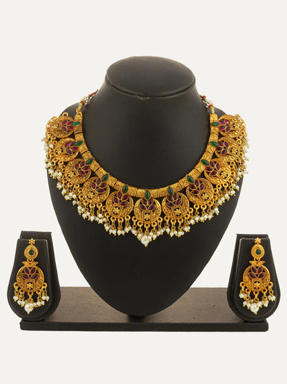 Gold necklace and earrings set on a black mannequin bust with a white background
