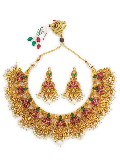 Gold necklace set with pink and green stones on a white background
