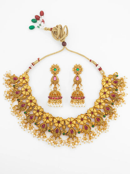 Gold necklace with matching earrings on a white background