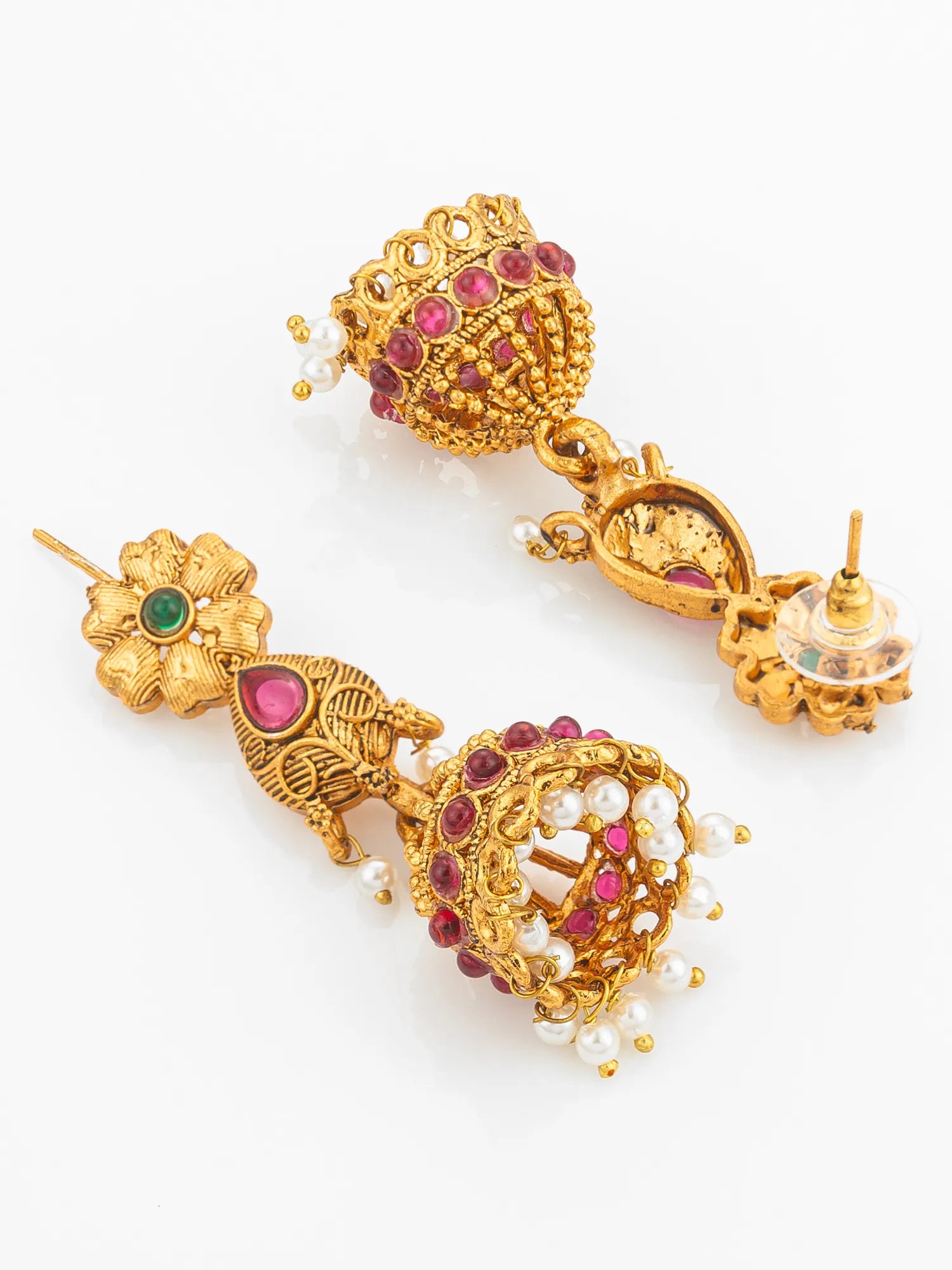 Gold earrings with gemstones and pearls on a white background