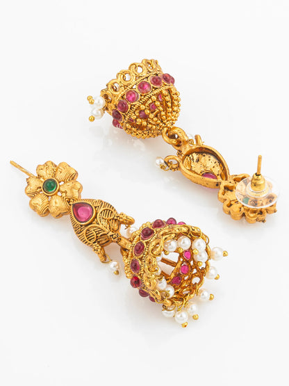 Gold earrings with gemstones and pearls on a white background