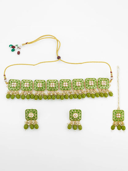 Green and gold jewelry set with necklace, earrings, and bangles on a white background