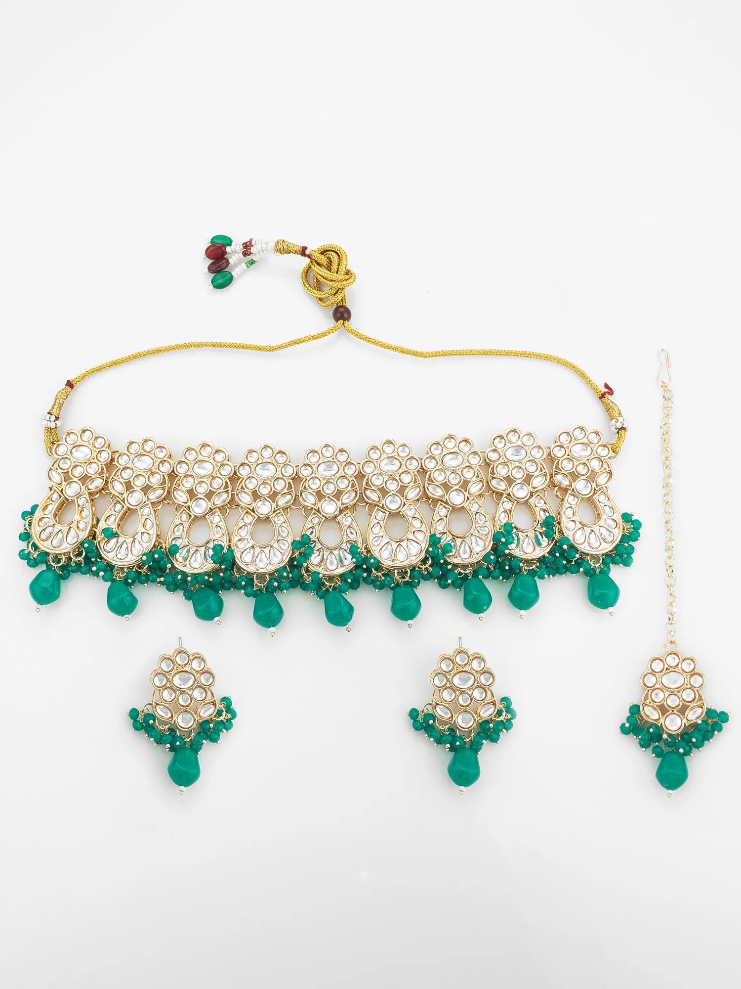Gold and green jewelry set including necklace, earrings, and headpiece on a white background