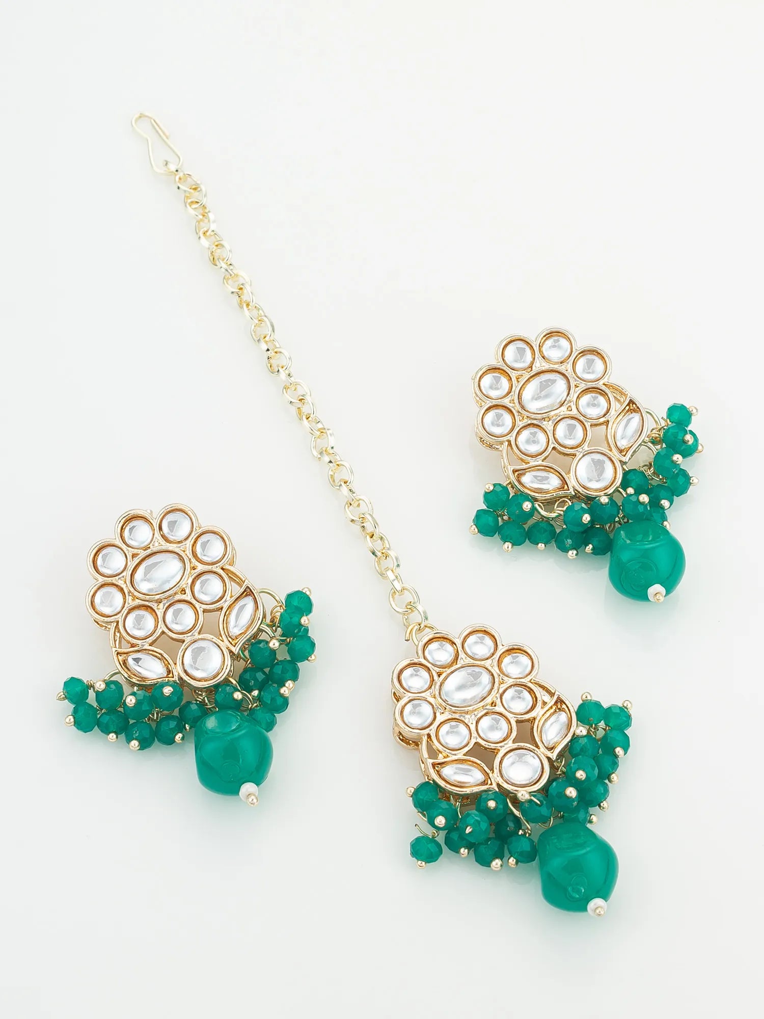 Gold and green beaded earrings on a white background