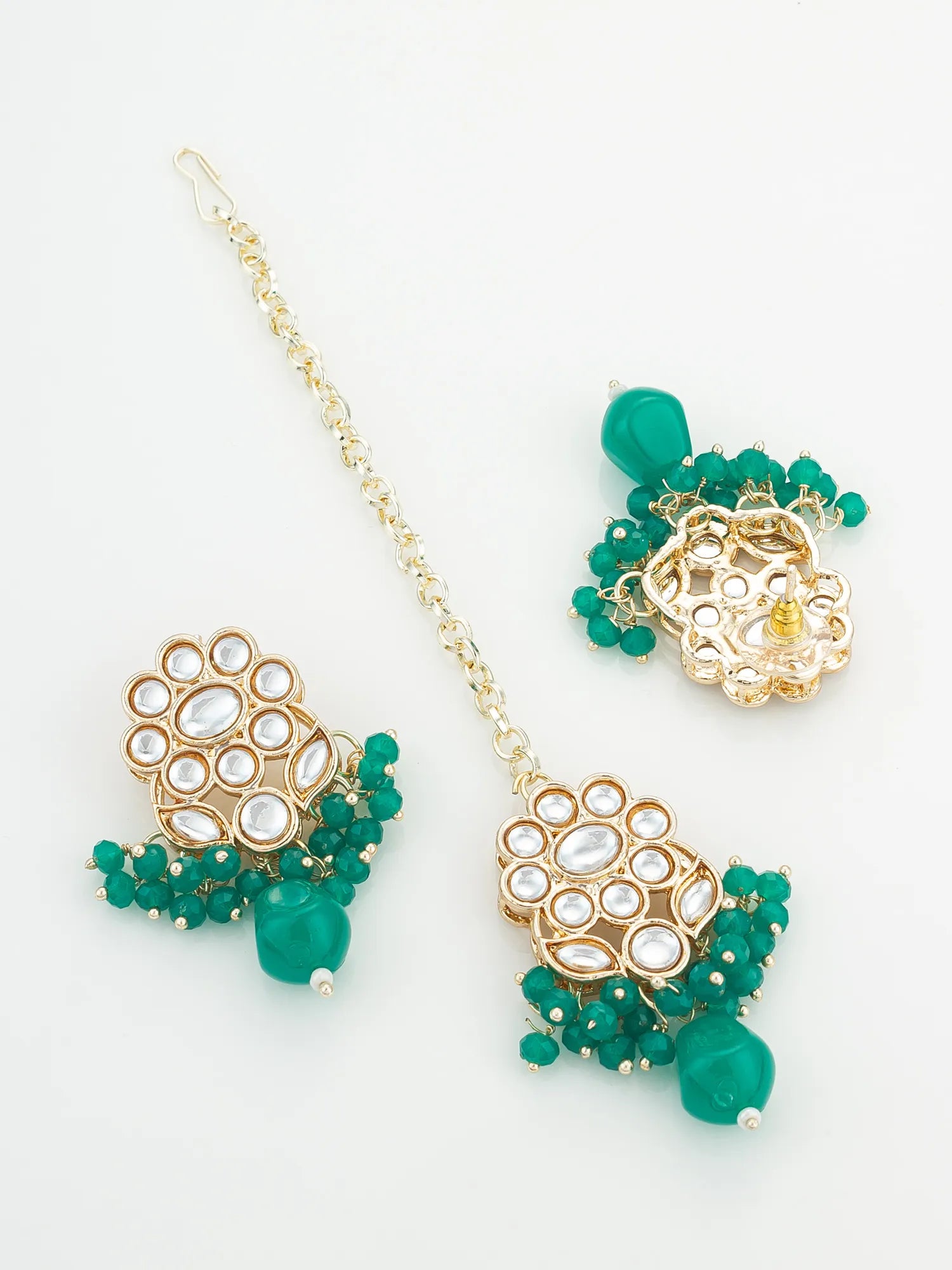 Gold and green beaded earrings on a white background