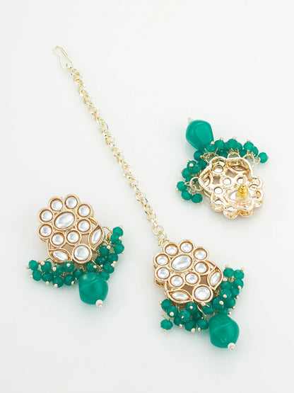 Gold and green beaded earrings on a white background