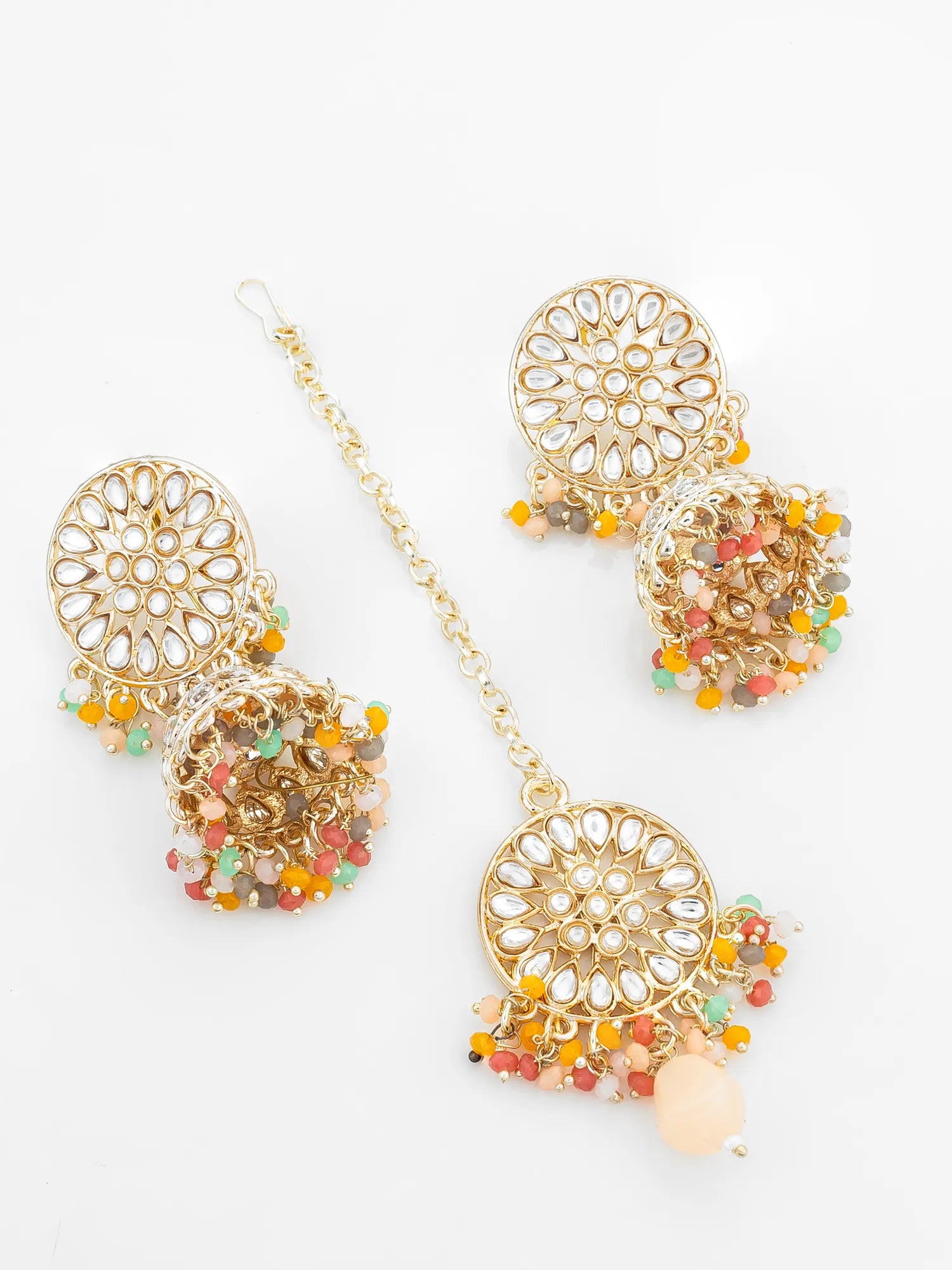 Gold earrings with colorful beads on a white background