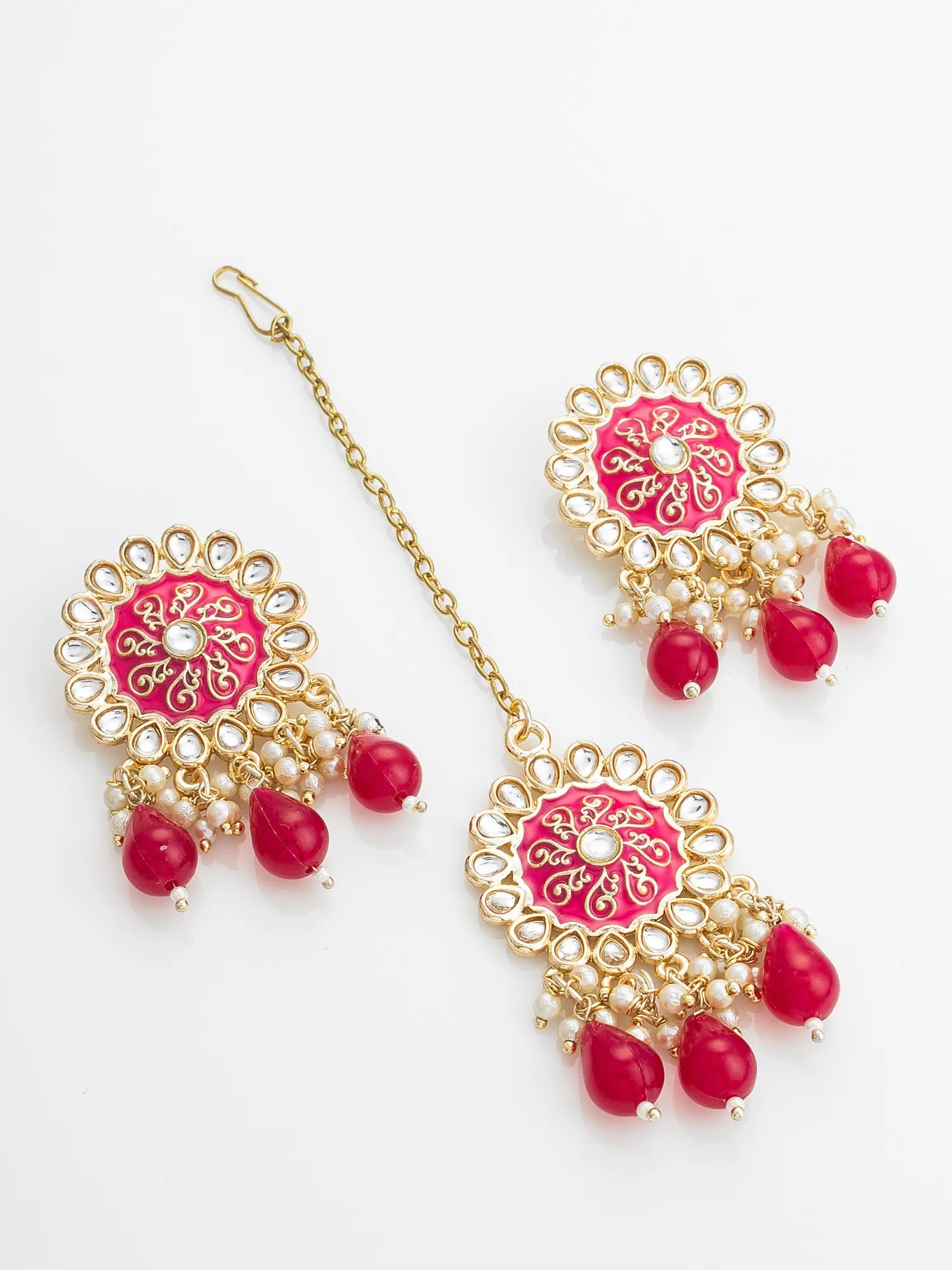Ornate earrings with pink and red stones on a white background
