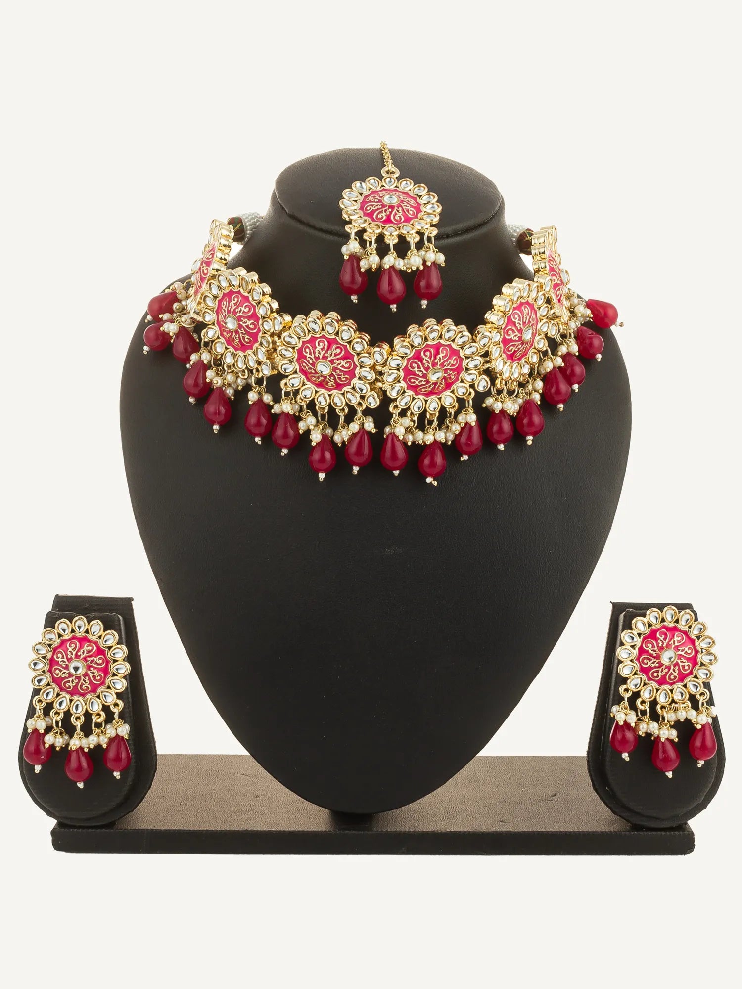 Jewelry set with necklace and earrings on a black stand