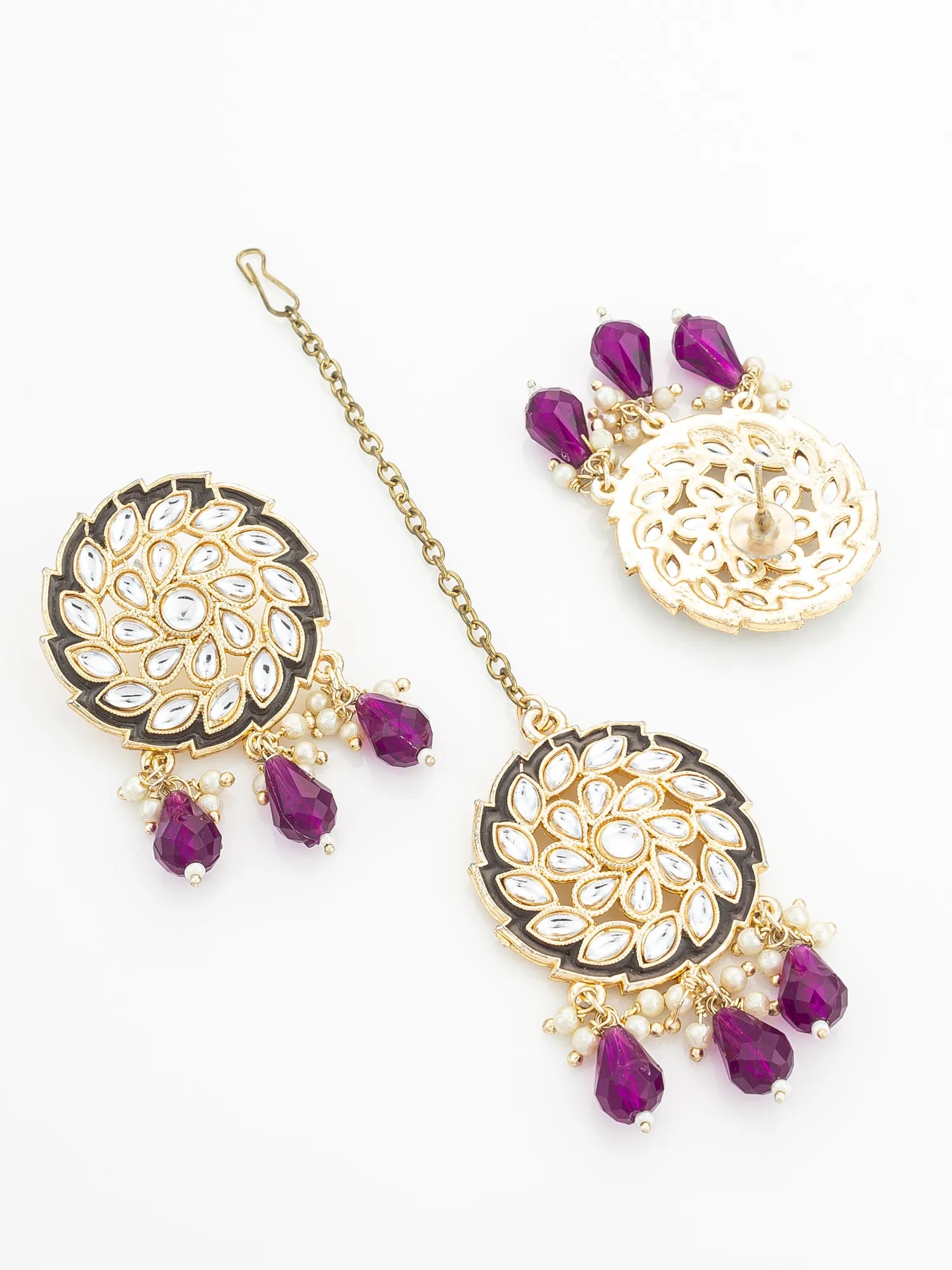 Ornate earrings with purple stones on a white background