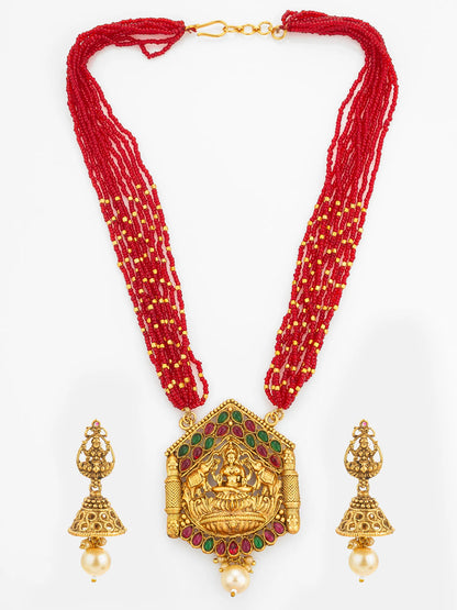 Red beaded necklace with gold pendant and earrings on a white background