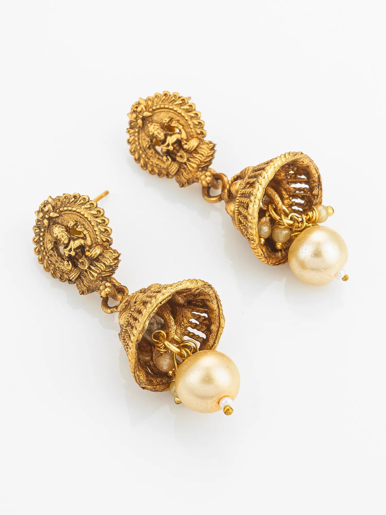 Gold earrings with pearl drops on a white background
