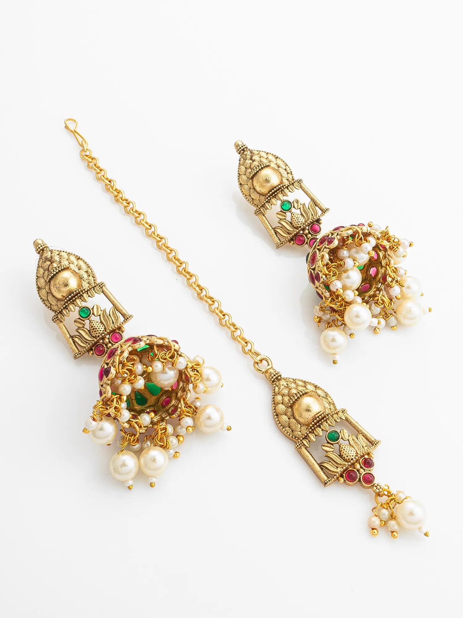 Ornate gold earrings with pearls and gemstones on a white background