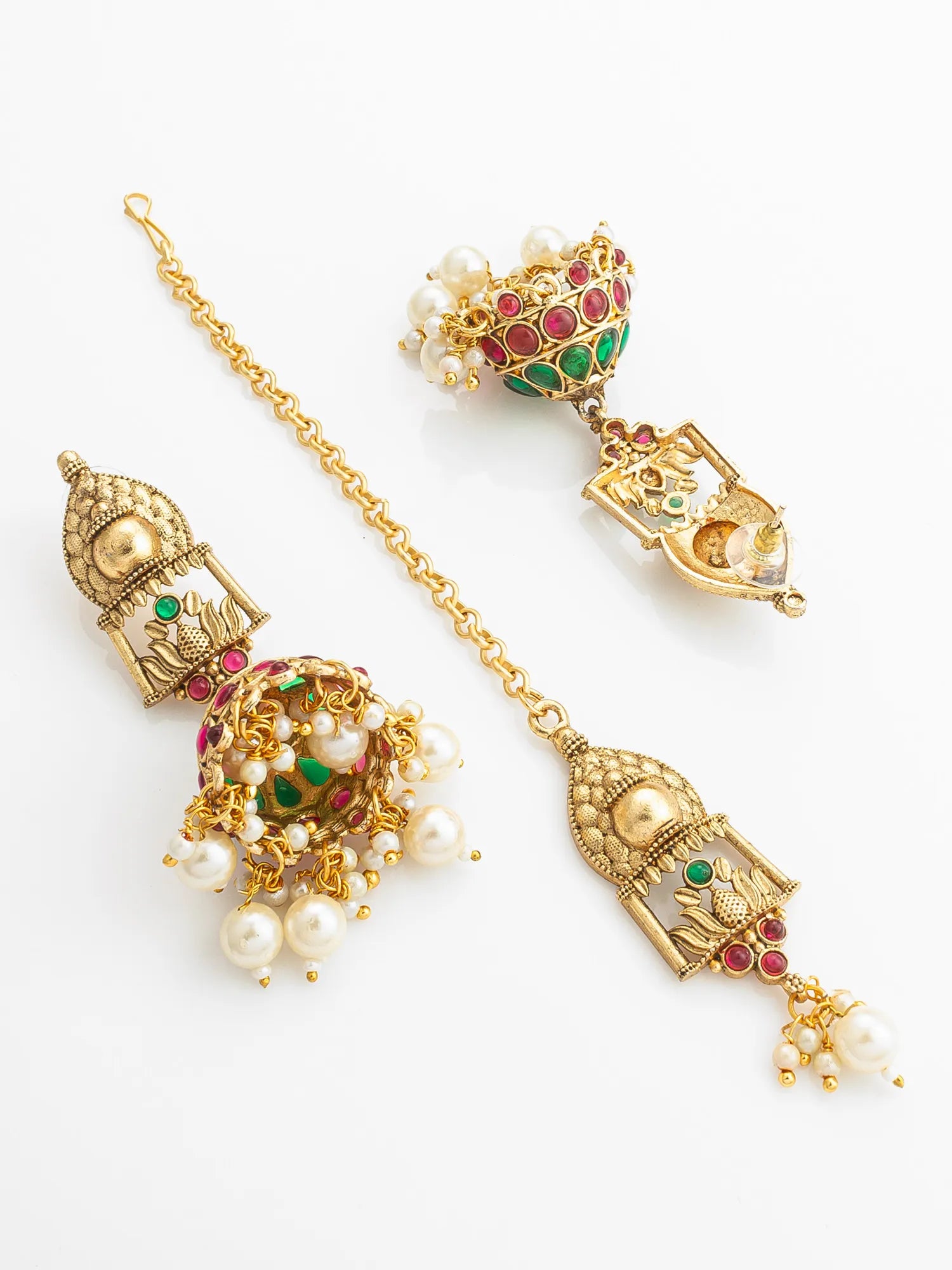 Ornate gold earrings with pearls and gemstones on a white background