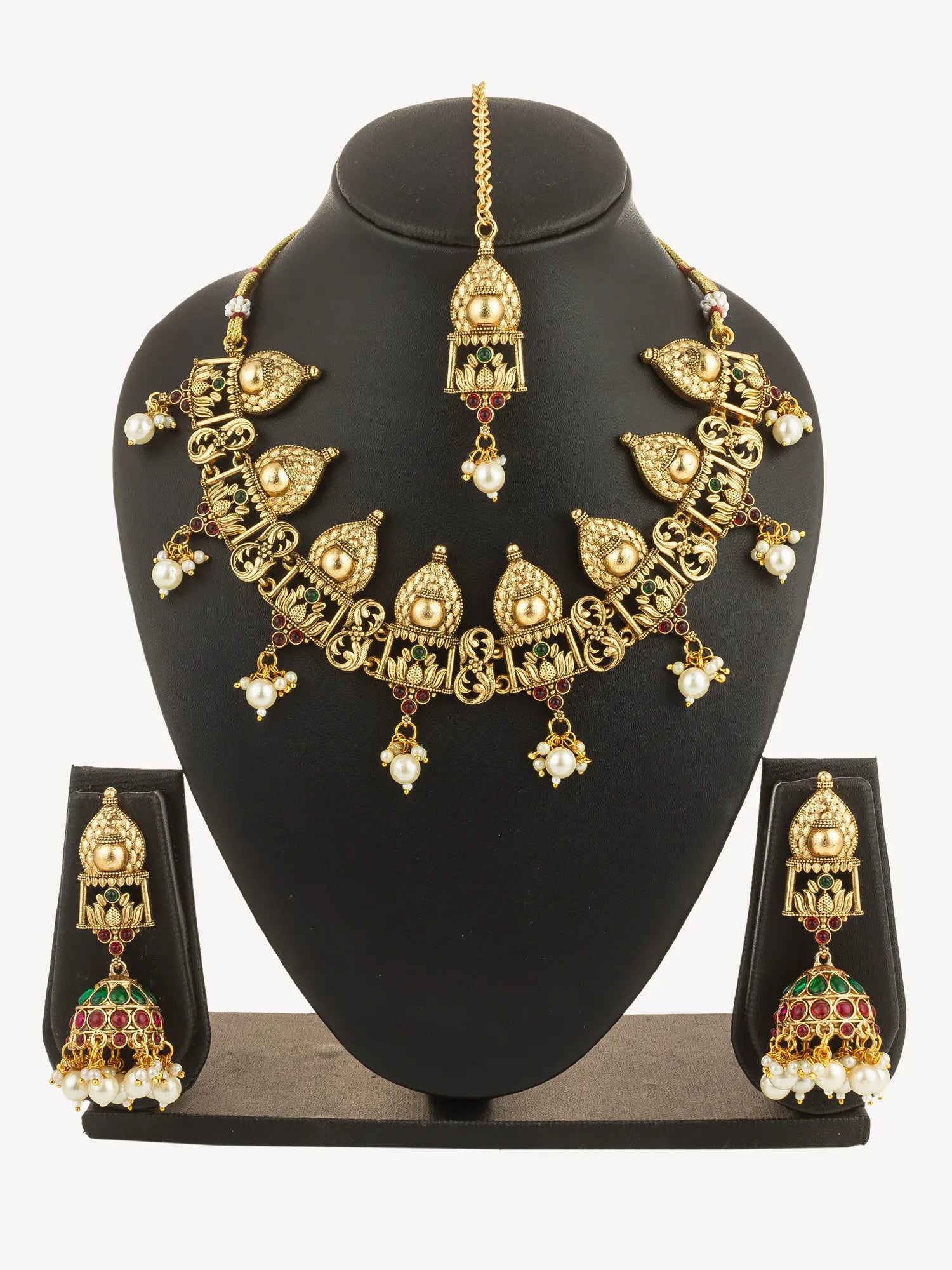 Gold necklace and earrings set on a black mannequin bust with a white background