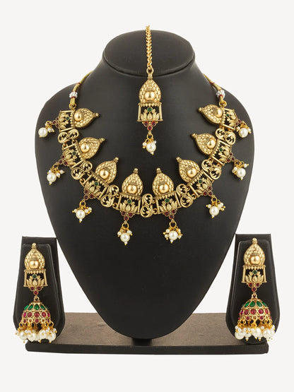 Gold necklace and earrings set on a black mannequin bust with a white background