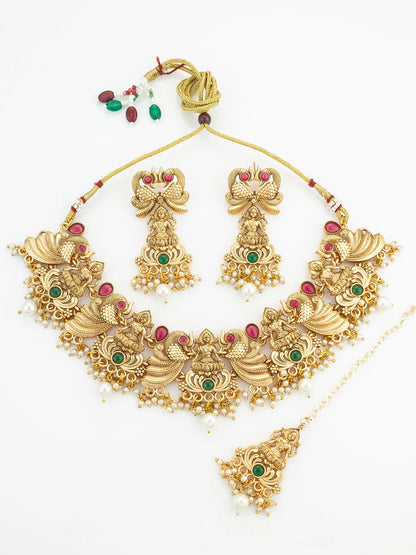 Gold necklace set with matching earrings on a white background