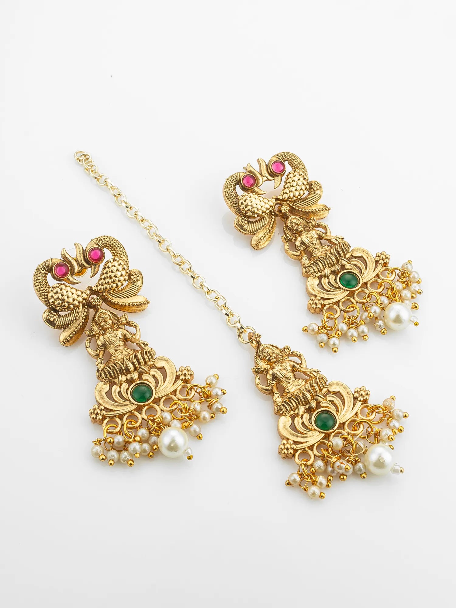 Gold jewelry set with earrings and a headband on a white background