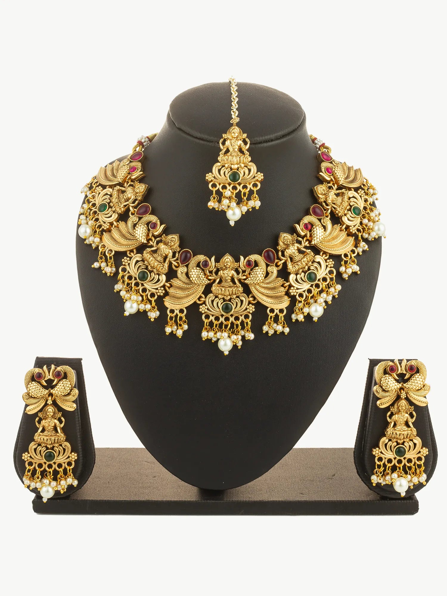 Gold jewelry set with necklace, earrings, and ring on a black stand