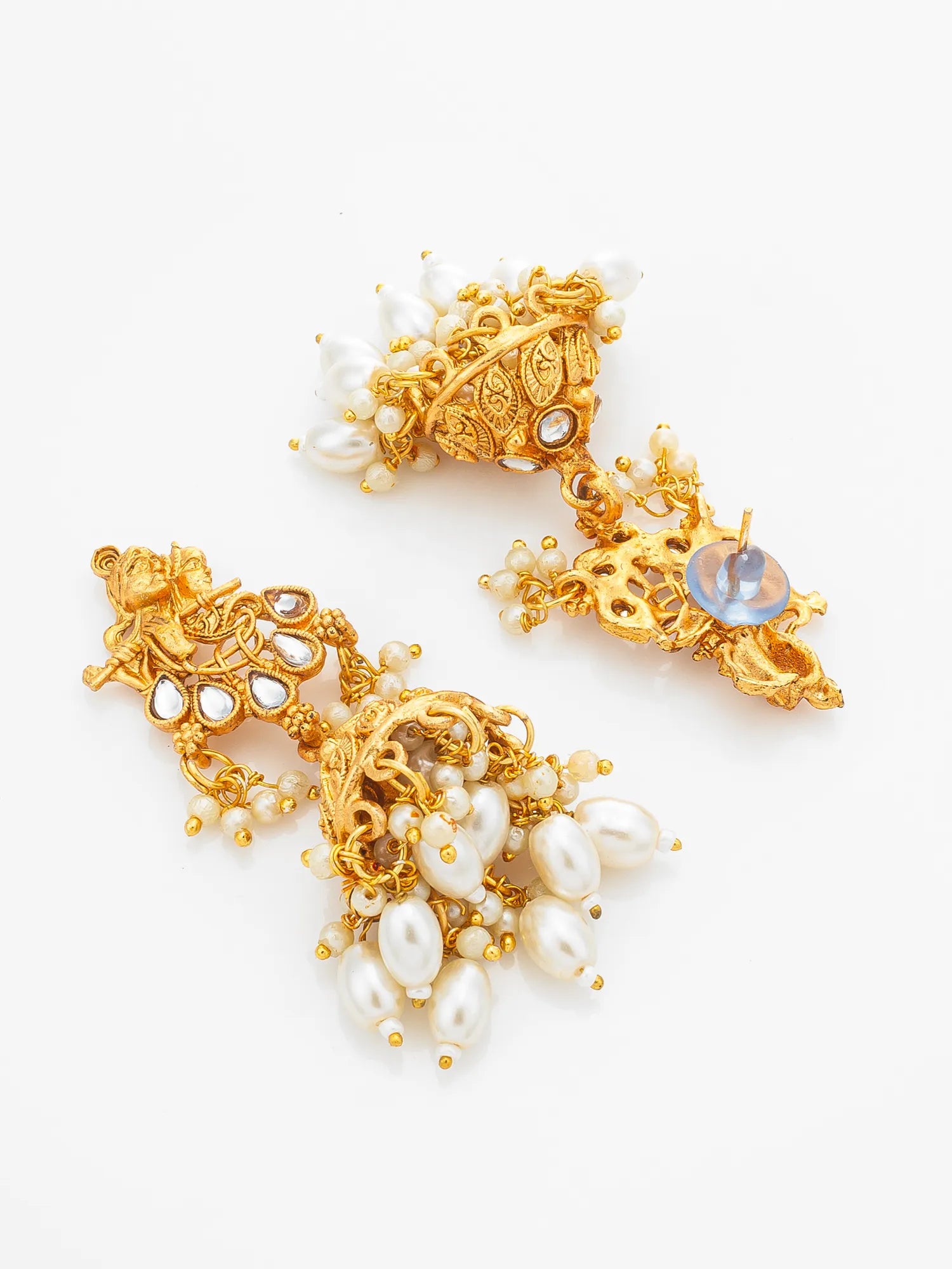 A pair of ornate gold-toned traditional earrings decorated with white pearls and a round iridescent blue stone, displayed on a clean white background.