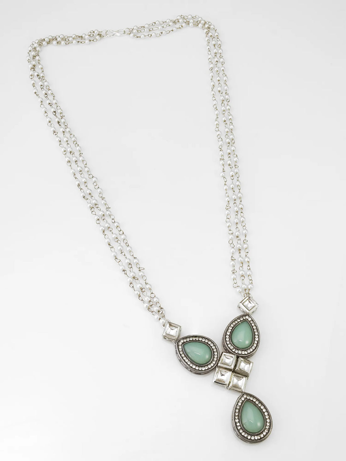 Necklace with turquoise stones and silver accents on a black background