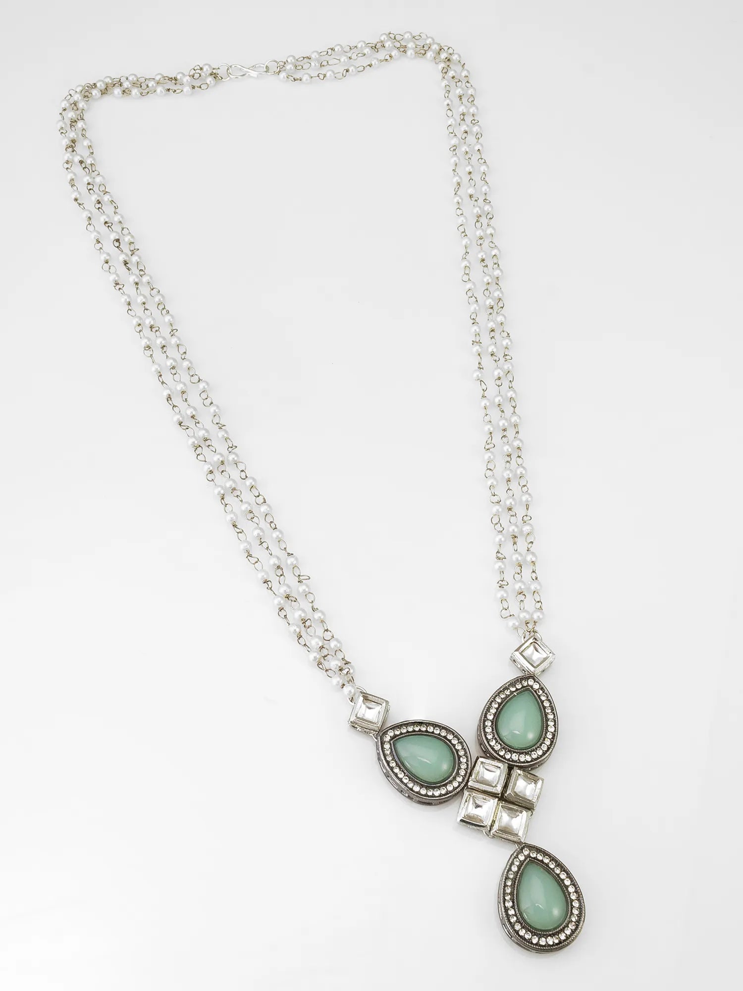Necklace with green teardrop pendants on a white background