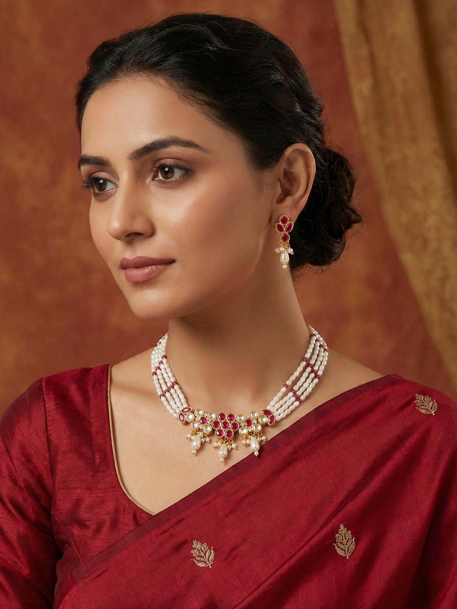 Aadita Gold Plated Multi-Strand Pearl Necklace with Red Stone Detail