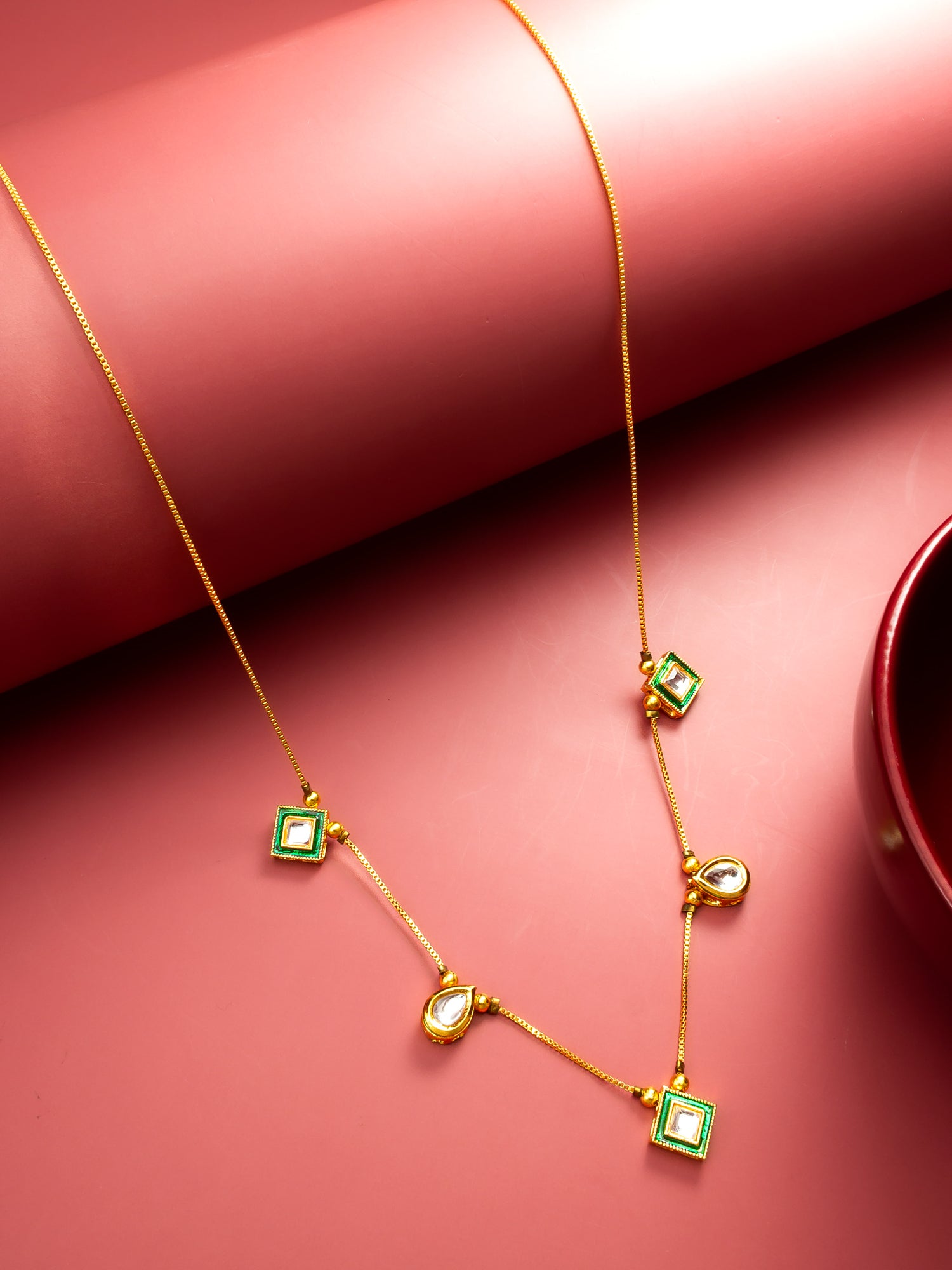 Aadita Gold Plated Kundan Necklace with Green Enamel and Multi-Shape Pendants