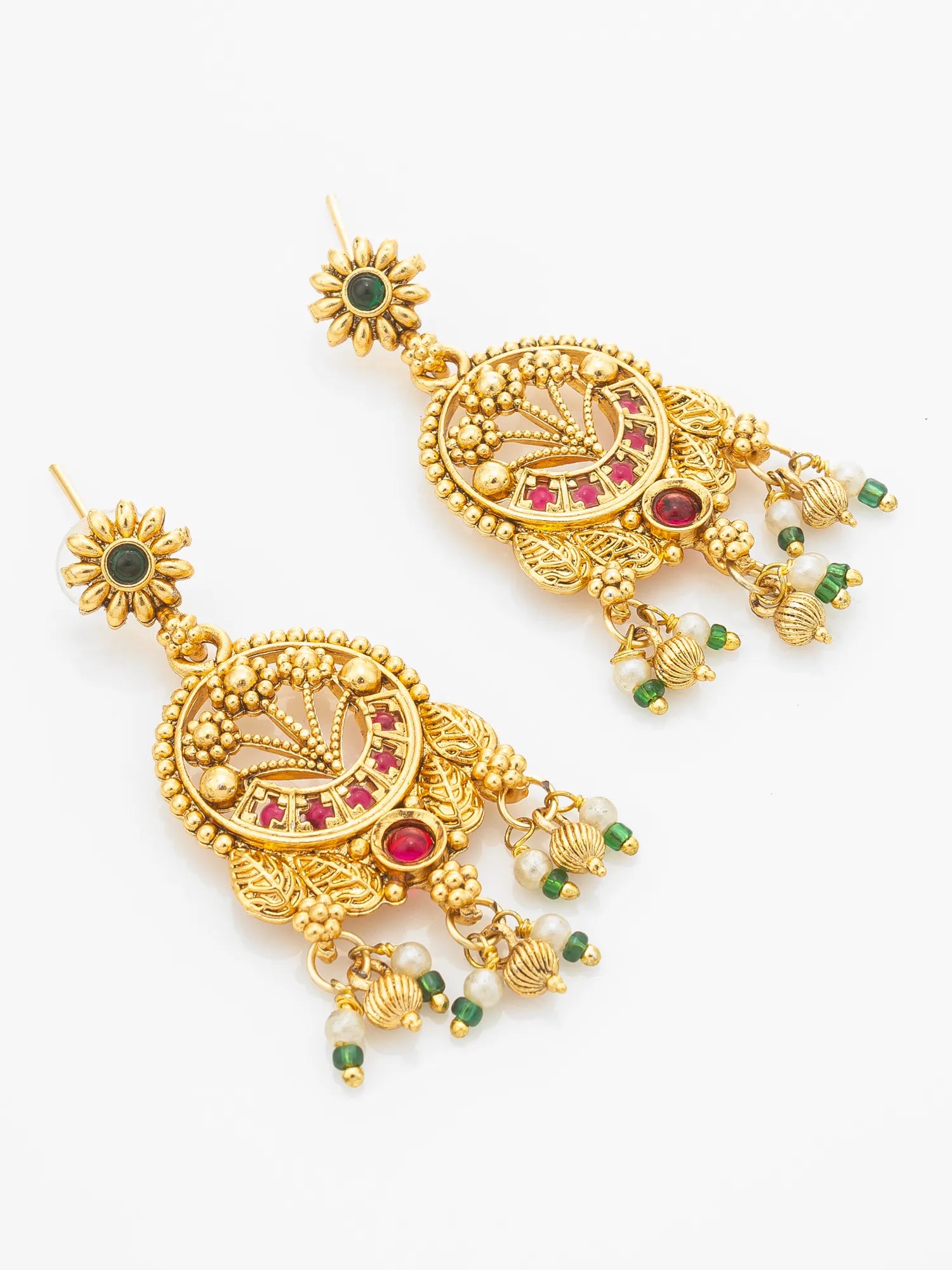 A pair of ornate gold-toned Indian jhumka earrings with green and red stone accents, shown on a plain white background.