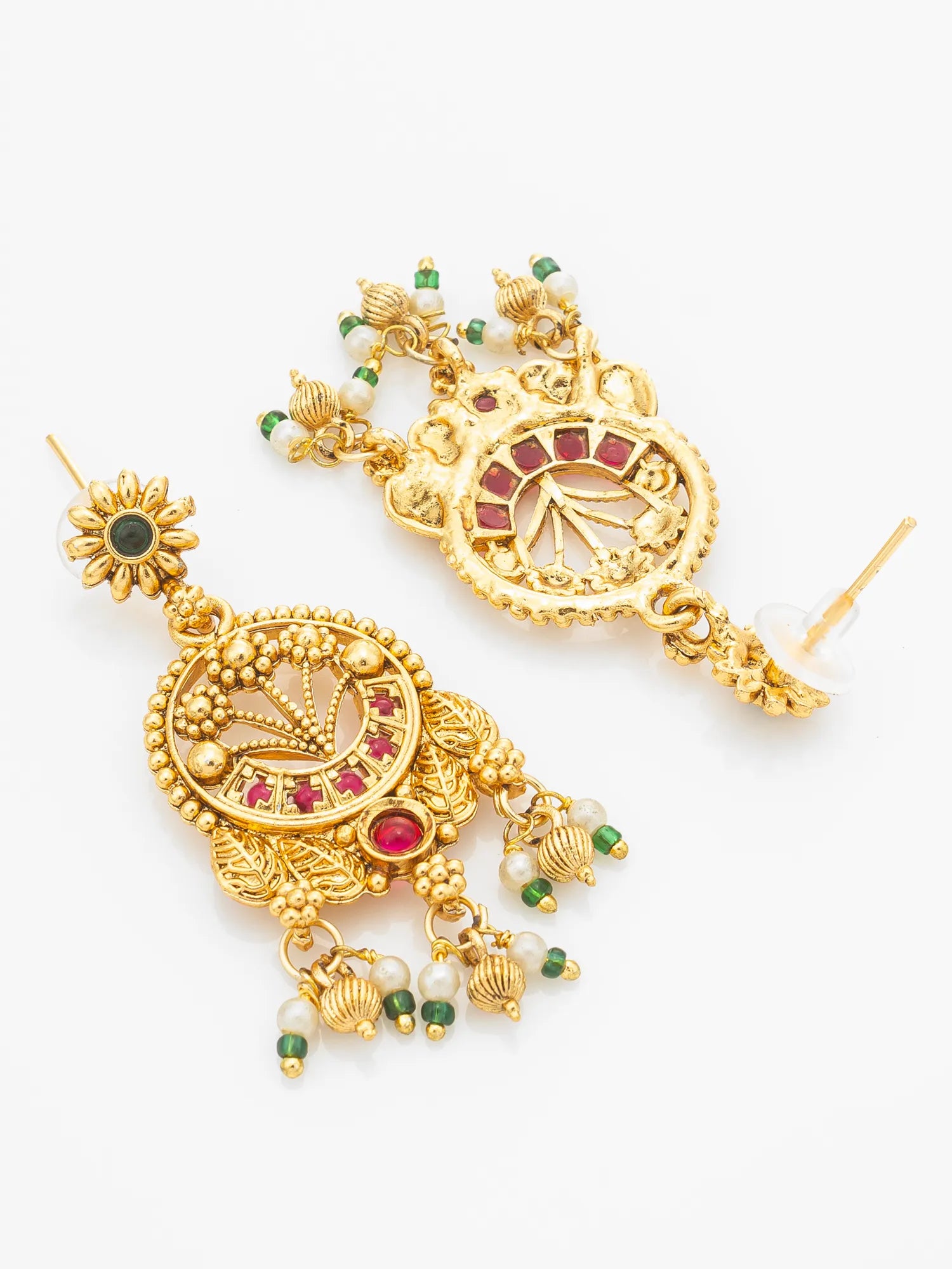 A pair of ornate gold-toned traditional Indian jhumka earrings decorated with red and green stones and white bead details, displayed on a clean white background.
