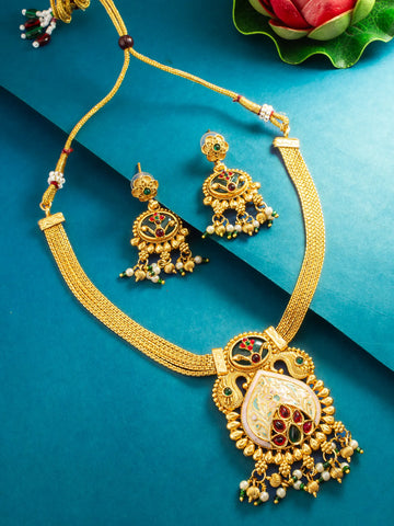 Gold-toned traditional jewelry set featuring a necklace and matching earrings with intricate multicolor enamel detailing, displayed on a teal background.
