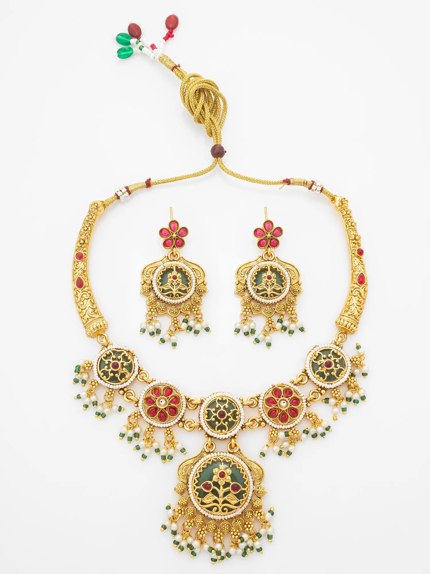 Gold-plated traditional Indian jewelry set featuring a necklace and matching earrings with red and green enamel details, displayed on a clean white background.