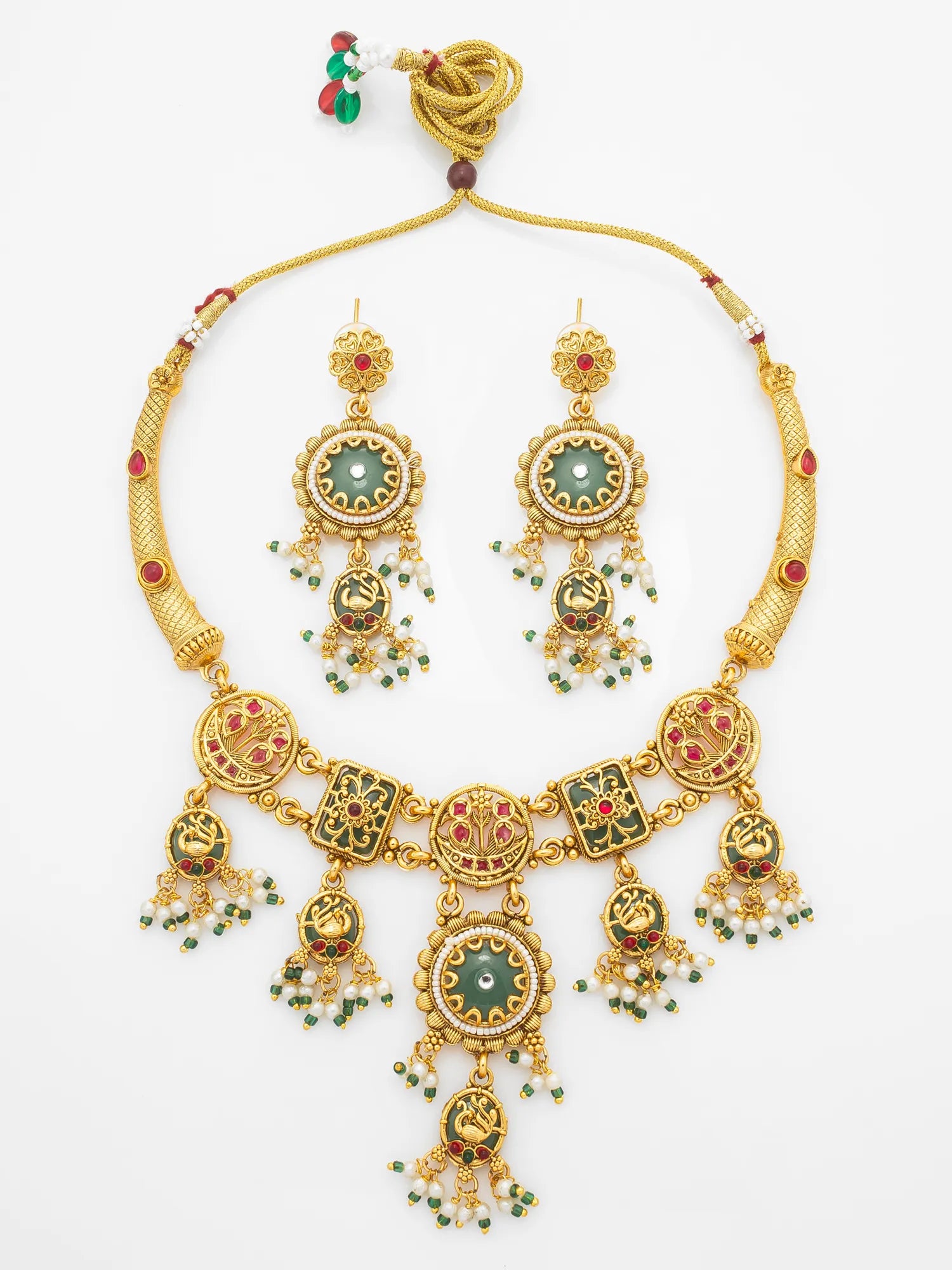 An ornate gold-toned traditional necklace and matching drop earrings with green and red enamel details, displayed on a clean white background.
