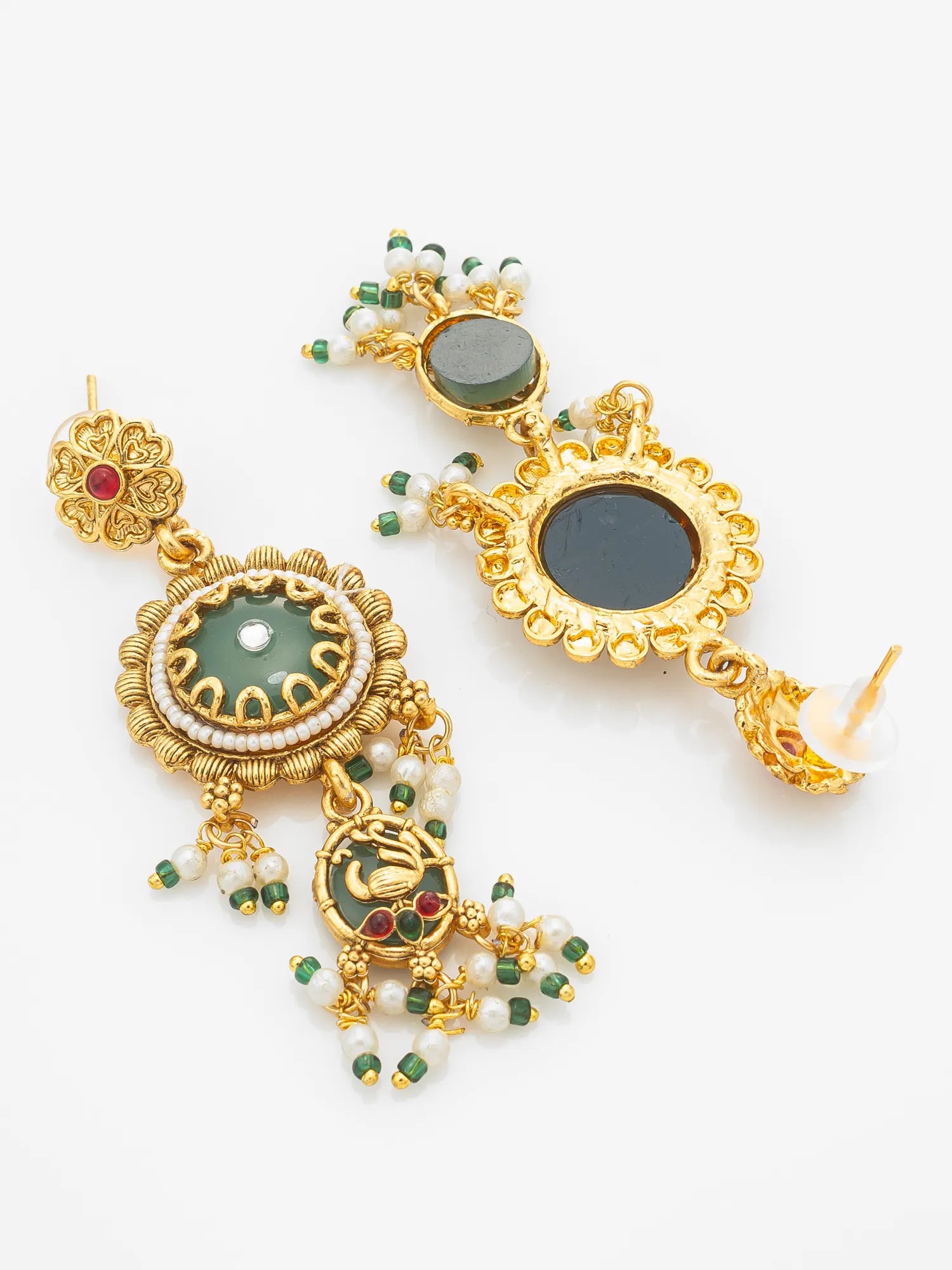 A pair of ornate gold-toned traditional earrings with green stone centers, white pearl bead strands, and small red and green accent stones, displayed on a clean white background.