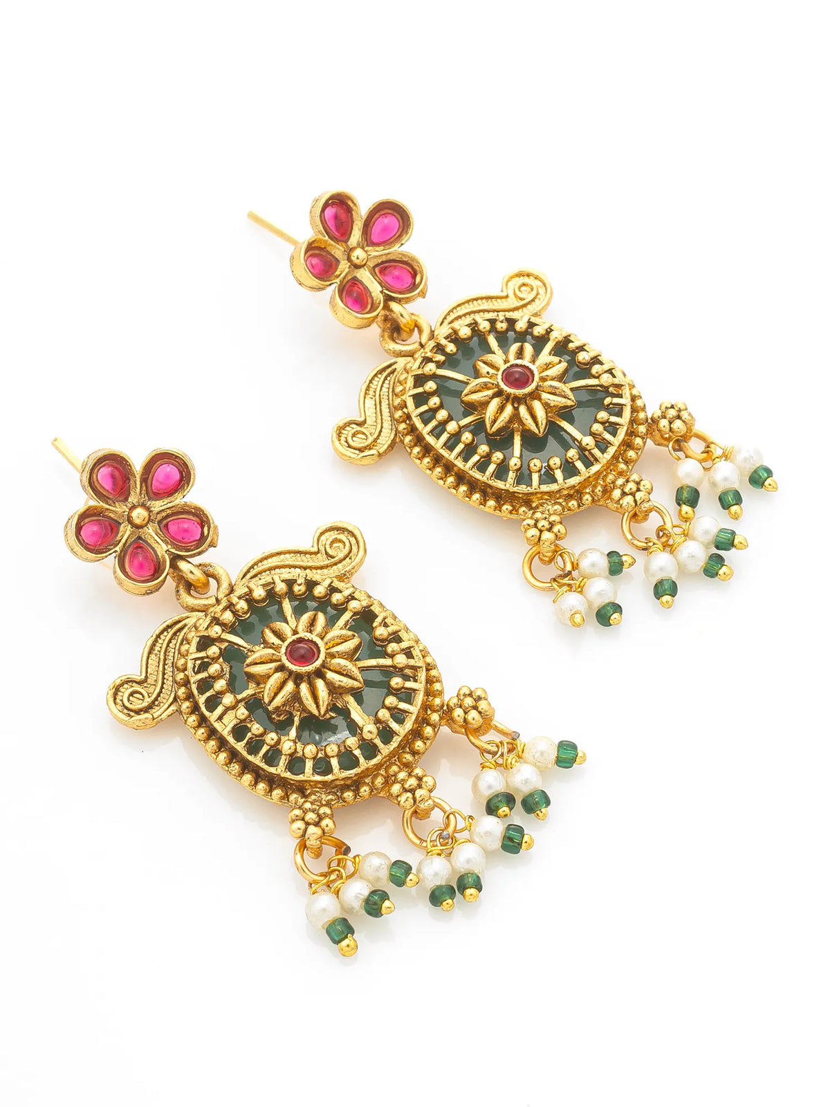 A pair of ornate gold-plated Indian jhumka earrings with green enamel, pink stone accents, and dangling white pearl beads on a white background.