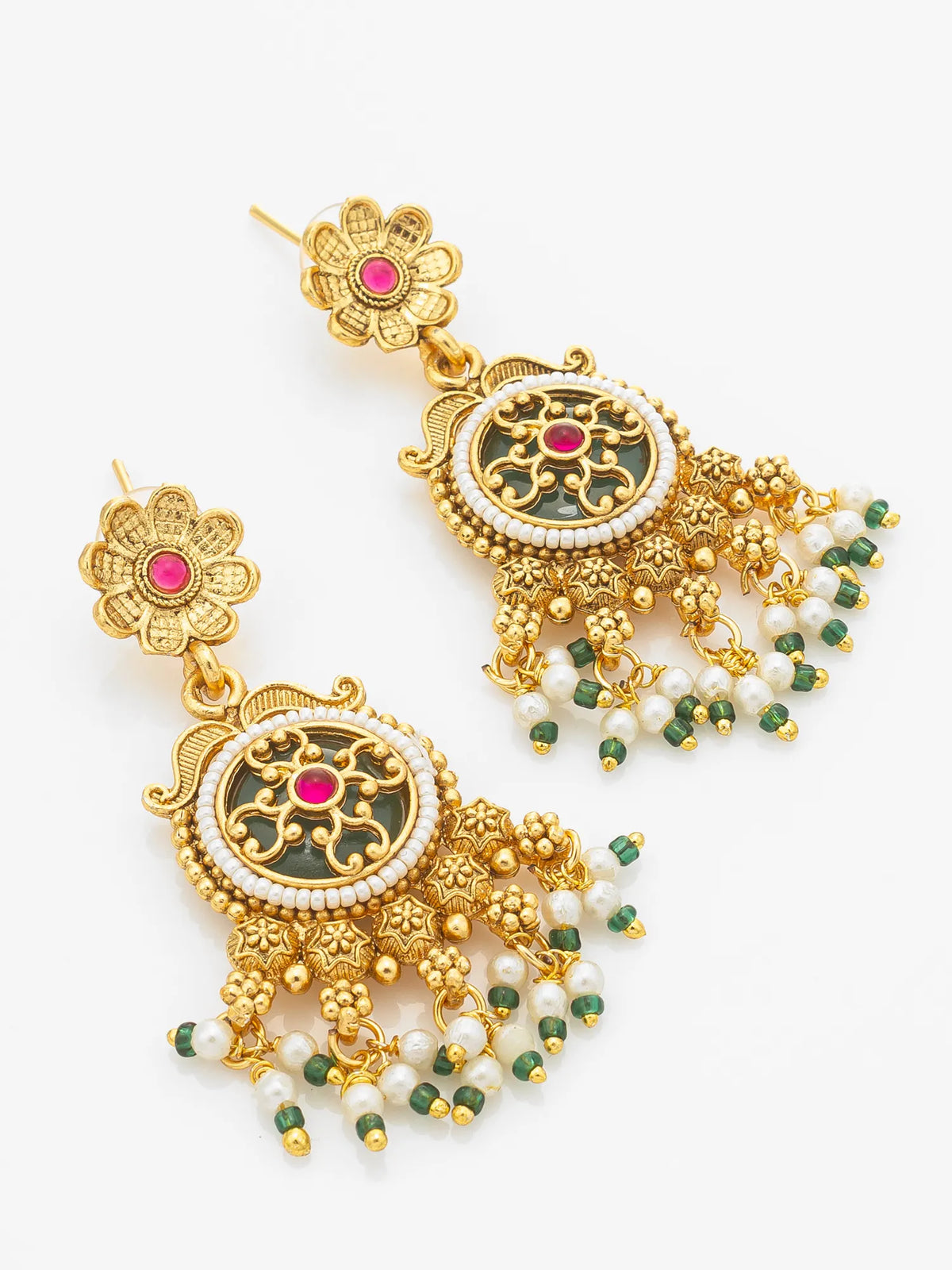 A pair of ornate gold-toned traditional Indian jhumka earrings with green and white bead tassels, white pearl-like borders, and pink stone accents on a plain white background.